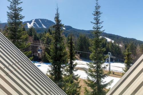 a view of a snow covered ski slope with trees at The Aspens by Whiski Jack in Whistler