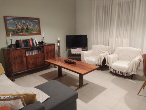 a living room with a couch and a coffee table at 3 STEPS in Alexandroupoli