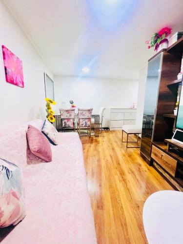 a living room with a bed and a table and chairs at Pacific Apartamento Surco in Lima