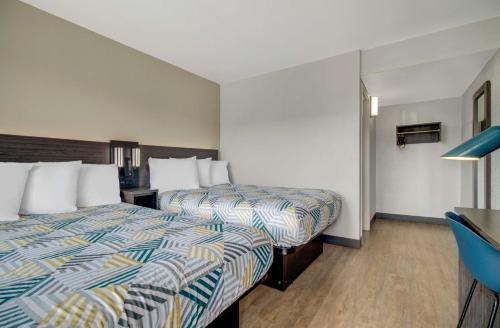 a hotel room with two beds and a desk at Motel 6-Venice, FL in Venice