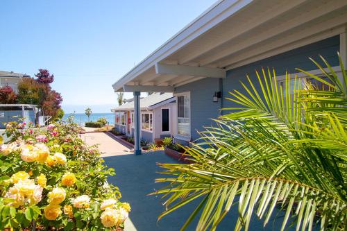 a house with flowers and plants in front of it at Edgewater Beach Inn in Santa Cruz
