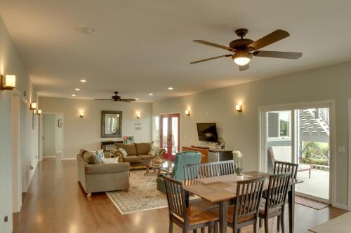 a living room with a ceiling fan and a table at The Aloha Green House Retreat with Ocean Views! in Naalehu