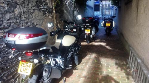 a group of motorcycles parked in a alley at Hotel Villa de Luarca in Luarca