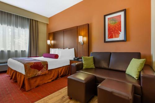 a hotel room with a bed and a couch at Best Western Plus Georgetown Corporate Center Hotel in Georgetown