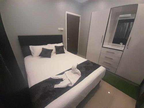 a small bedroom with a bed and a mirror at Prasad Apartments in Labasa