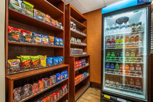 a grocery store aisle with a refrigerator filled with drinks at Best Western Plus Georgetown Corporate Center Hotel in Georgetown