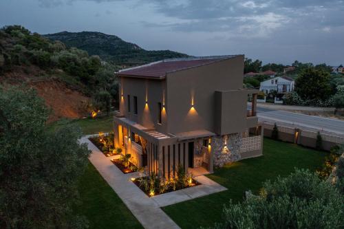 an aerial view of a house with lights at Pournari Mountain Rooms in Toroni