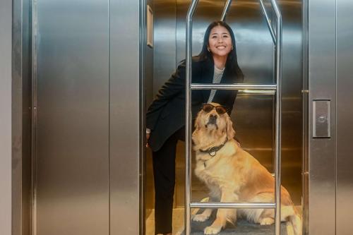 a woman and a dog in an elevator at Park Inn by Radisson Oslo Airport Hotel West in Gardermoen