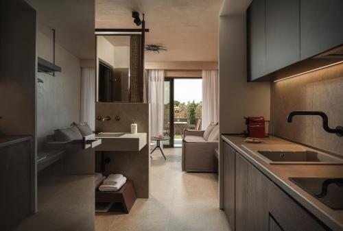 a kitchen with a sink and a counter top at Pournari Mountain Rooms in Toroni