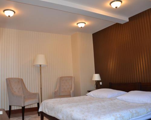 Ένα ή περισσότερα κρεβάτια σε δωμάτιο στο Hotel Nowodworski