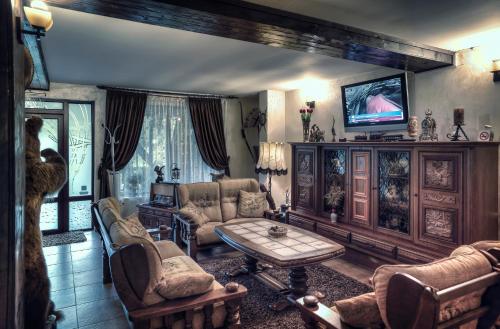 a living room with a couch and a table at La Bucovineanca in Strîmtura