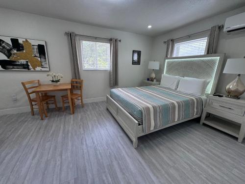 a bedroom with a bed and a table and a desk at Stylish Studio Apartment By Miami International Airport in Miami