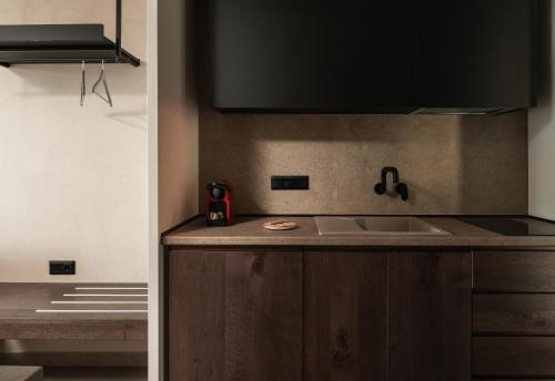 a kitchen with a sink and a counter top at Pournari Mountain Rooms in Toroni
