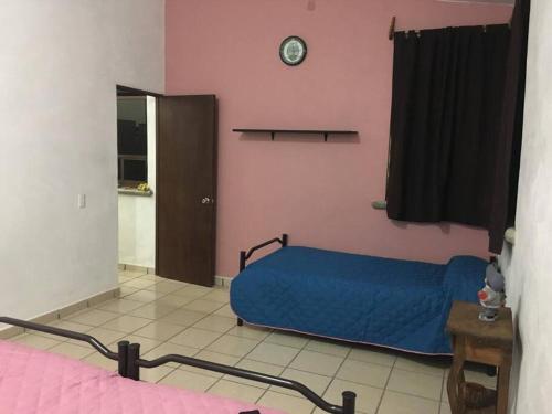Postel nebo postele na pokoji v ubytování Casa Familiar Tepeji