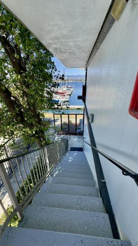 a staircase leading down to the water with a boat at Marina Village Inn in Alameda