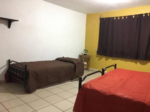 Postel nebo postele na pokoji v ubytování Casa Familiar Tepeji