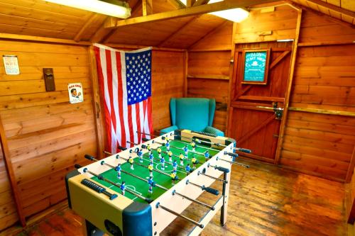 a room with a foosball table and an american flag at A Luxurious Home with Hot Tub and Man Cave! 9ppl in Whiston