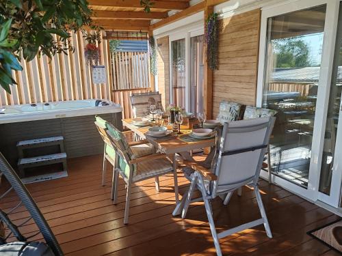 a porch with a table and chairs on a deck at Annika Mar in Selce