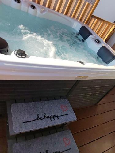 a jacuzzi tub on a deck with a sign at Annika Mar in Selce