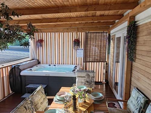 a jacuzzi tub on a deck with a table at Annika Mar in Selce