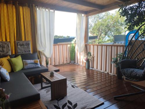 a living room with a couch on a wooden deck at Annika Mar in Selce