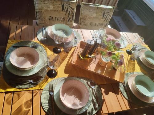 a wooden table with plates and dishes on it at Annika Mar in Selce