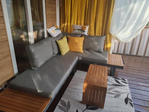 a couch sitting on a balcony with a table at Annika Mar in Selce