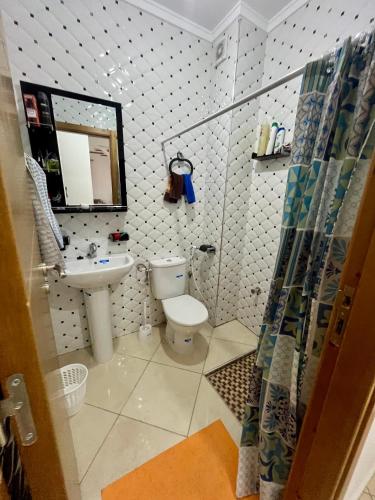 a small bathroom with a toilet and a sink at Paraiso Costero Azla Tetouan in Azla
