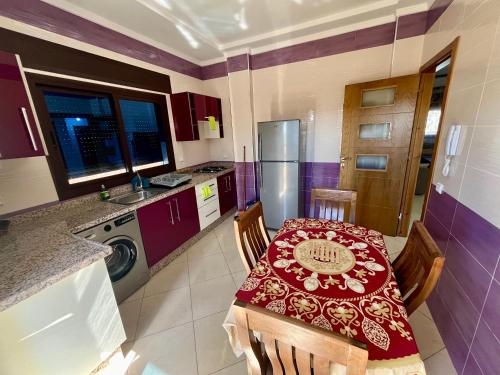 a kitchen with a table with a red table cloth at Paraiso Costero Azla Tetouan in Azla