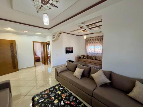 a living room with a couch and a table at Paraiso Costero Azla Tetouan in Azla