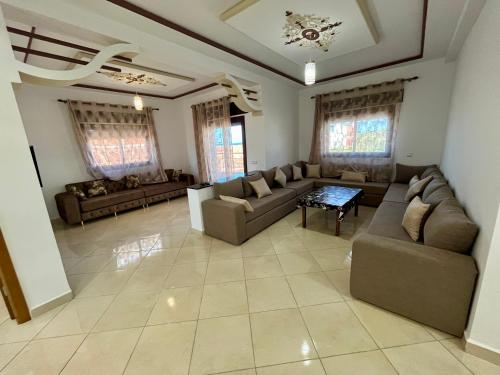 a large living room with couches and a table at Paraiso Costero Azla Tetouan in Azla