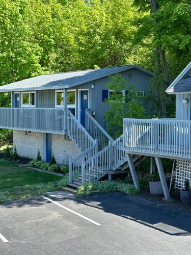 a house with a blue door and stairs in a parking lot at DownTown Inn in Sister Bay