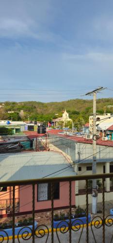 a view of a town with a building and water at Casa Oro Eco Hostel in San Juan del Sur