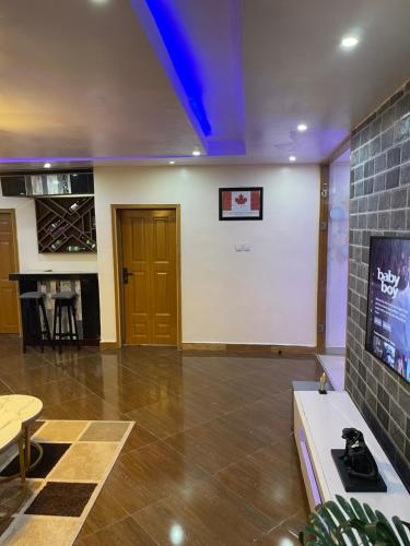 a large room with a white wall and a door at 24-Hour Electricity An Entire Stylish 4-Bedroom Bungalow in Akure