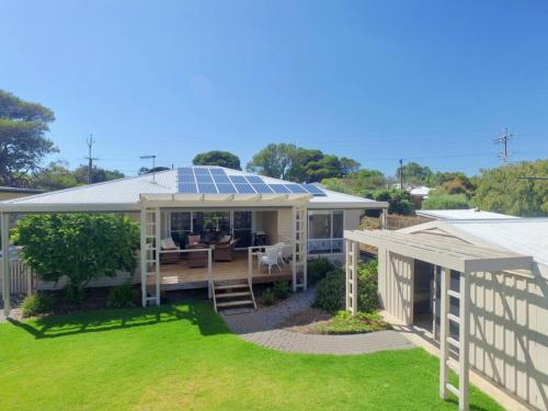 a house with a solar roof with a yard at Rose Villa - Port Willunga in Port Willunga