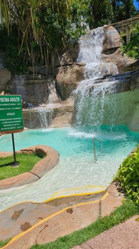a water slide in a park with a waterfall at Hotel Luupi Esmeralda Apto 159 - Rio Quente GO in Rio Quente
