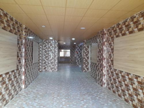 a hallway of a room with brick walls at Pizza Street Hostel in Aqaba
