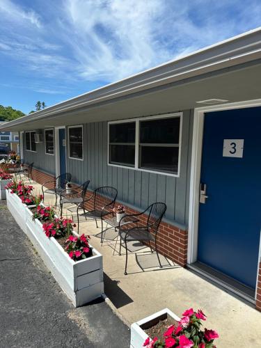 a group of chairs and flowers outside of a house at DownTown Inn in Sister Bay