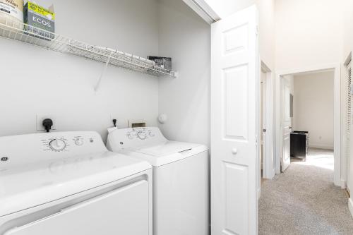 a white laundry room with a washer and dryer at Newly Renovated Delray Beach Townhome in Delray Beach