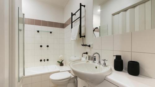 a white bathroom with a sink and a toilet at Higgi Drive 6 in Mount Hotham