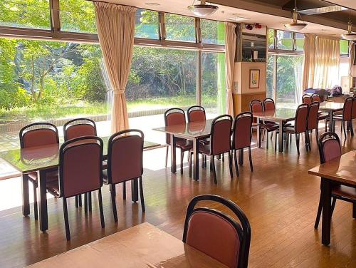 a classroom with tables and chairs and a large window at Osaka Moriguchi Plaza Hotel in Osaka