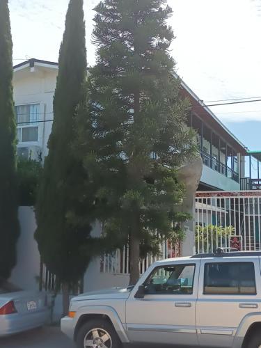 a white suv parked in front of a tree at Apartamentos Rosarito.!! Con Vista al Mar ! in Rosarito