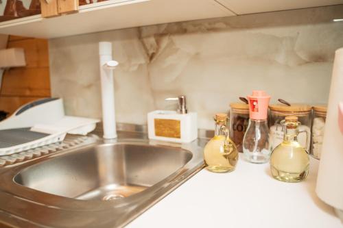 a kitchen sink with two bottles on the counter at Eka's Village in Plav