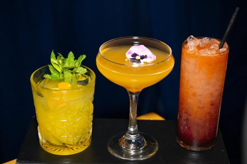 two cocktails sitting on a table next to at Hollywood Historic Hotel in Los Angeles