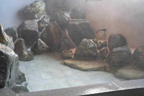 a rock shower in a room with a bunch of rocks at HOTEL FARO manazuru - Vacation STAY 56472v in Manazuru