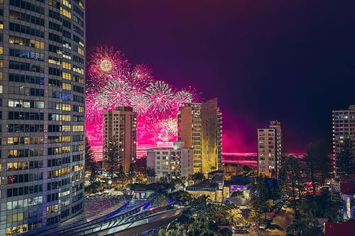 a city skyline with fireworks exploding in the sky at Wyndham Resort Surfers Paradise in Gold Coast