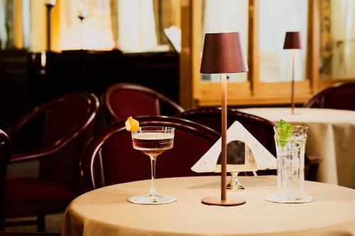 a table with two glasses and a lamp on it at Hotel Camigliatello in Camigliatello Silano