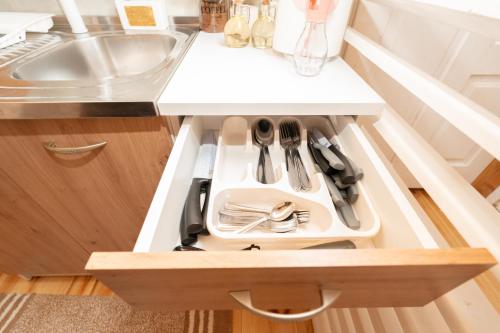 a kitchen cabinet with a plate and utensils on it at Eka's Village in Plav