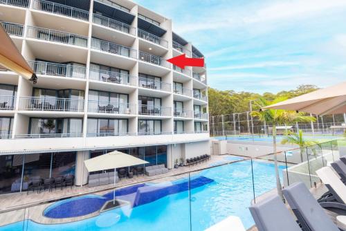 an image of a hotel with a swimming pool at The Landmark unit 405 Resort style, spectacular water views, lift, linen, pool, games room, port-a-cot and highchair. in Nelson Bay