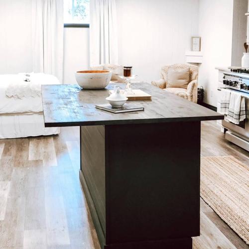 a kitchen with a large island in a living room at Cellar Suite at Winery and Vineyard in Waterford